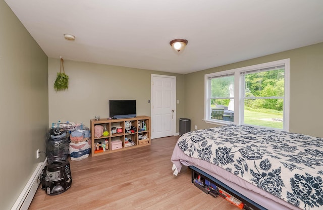 59 Milton Mills Rd, Lebanon, ME 04027 - bedroom with a baseboard heating unit and wood finished floors