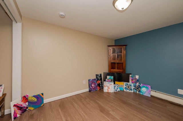 59 Milton Mills Rd, Lebanon, ME 04027 - rec room with wood finished floors, baseboards, and a baseboard radiator