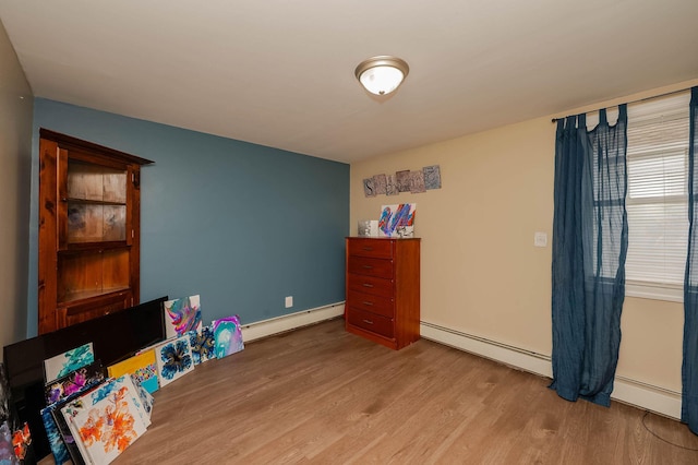 59 Milton Mills Rd, Lebanon, ME 04027 - playroom featuring a baseboard heating unit and wood finished floors