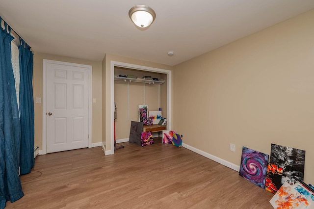 59 Milton Mills Rd, Lebanon, ME 04027 - recreation room featuring light wood-style flooring, baseboards, and a baseboard radiator