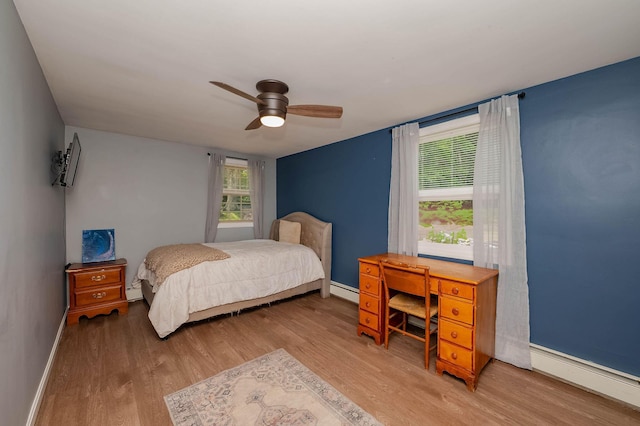 59 Milton Mills Rd, Lebanon, ME 04027 - bedroom with wood finished floors, baseboard heating, baseboards, and ceiling fan