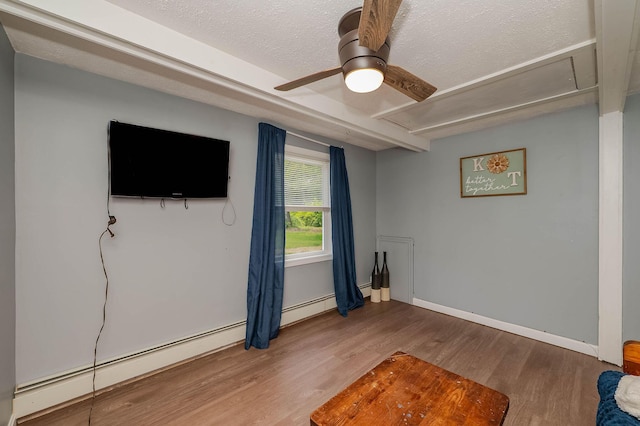 59 Milton Mills Rd, Lebanon, ME 04027 - unfurnished living room featuring attic access, wood finished floors, a textured ceiling, a ceiling fan, and baseboards