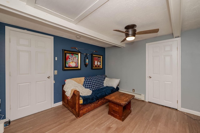 59 Milton Mills Rd, Lebanon, ME 04027 - sitting room featuring baseboard heating, light wood-style flooring, a ceiling fan, a textured ceiling, and baseboards
