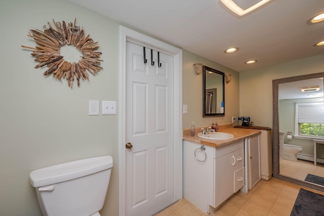 59 Milton Mills Rd, Lebanon, ME 04027 - bathroom featuring toilet, vanity, recessed lighting, and a baseboard heating unit