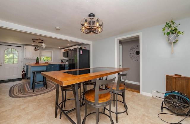 59 Milton Mills Rd, Lebanon, ME 04027 - dining area featuring a baseboard radiator, a chandelier, and baseboards