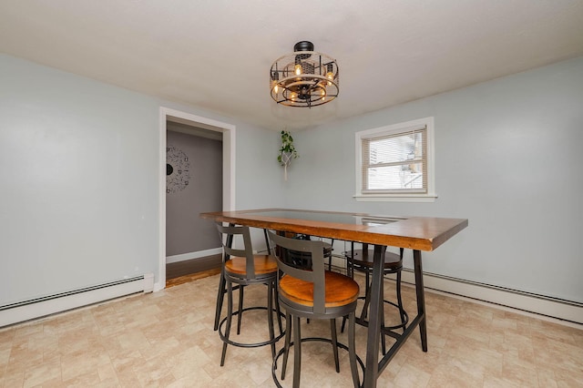 59 Milton Mills Rd, Lebanon, ME 04027 - dining room with a baseboard radiator, a chandelier, baseboards, and light flooring