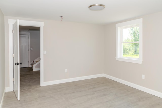 44 Bailey Rd, Cambridge, ME 04923 - empty room with baseboards, light wood finished floors, and stairway