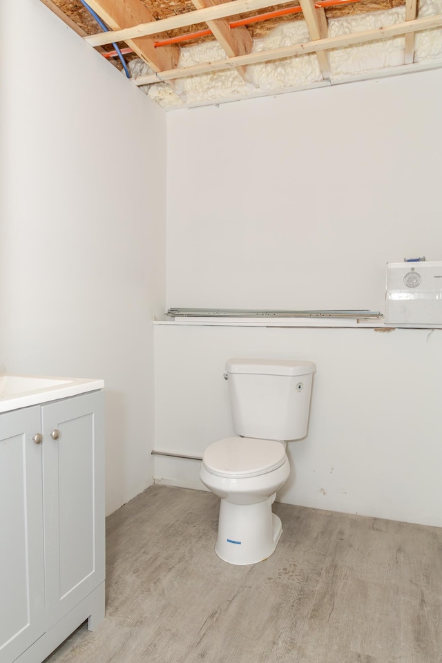 44 Bailey Rd, Cambridge, ME 04923 - bathroom with toilet, vanity, and wood finished floors