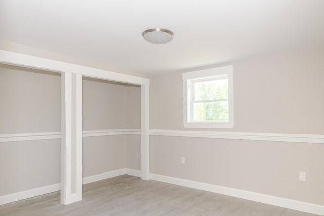 44 Bailey Rd, Cambridge, ME 04923 - unfurnished bedroom with wood finished floors, baseboards, and multiple closets