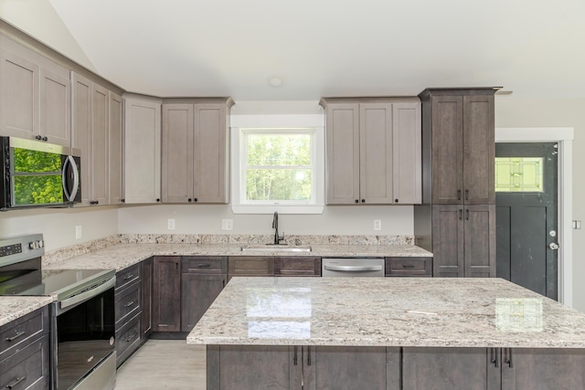 44 Bailey Rd, Cambridge, ME 04923 - kitchen featuring appliances with stainless steel finishes, a sink, light stone countertops, and light wood finished floors