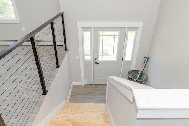 44 Bailey Rd, Cambridge, ME 04923 - entrance foyer featuring light wood-style floors, stairway, baseboards, and a baseboard heating unit