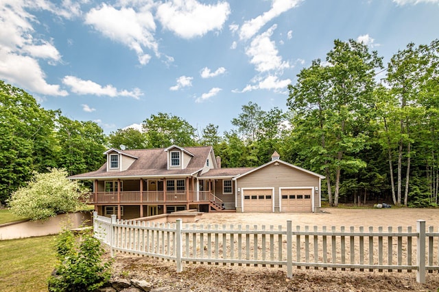 321 Riverbend Rd, Brownfield, ME 04010 - view of front of property featuring a garage, covered porch, dirt driveway, and a fenced front yard