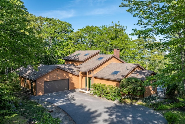 5 Spring Mountain Dr, Rockport, ME 04856 - rustic home featuring driveway, a chimney, an attached garage, and roof with shingles