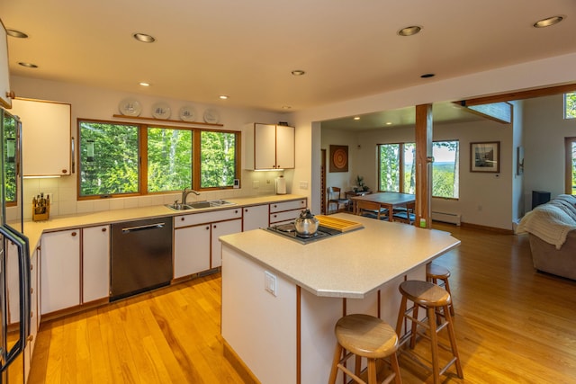 5 Spring Mountain Dr, Rockport, ME 04856 - kitchen with dishwashing machine, light countertops, a sink, cooktop, and light wood-type flooring