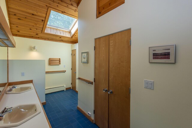 5 Spring Mountain Dr, Rockport, ME 04856 - full bath featuring a baseboard radiator, a skylight, double vanity, lofted ceiling, and wood ceiling