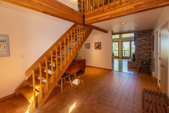 5 Spring Mountain Dr, Rockport, ME 04856 - staircase with baseboards, tile patterned flooring, and a towering ceiling