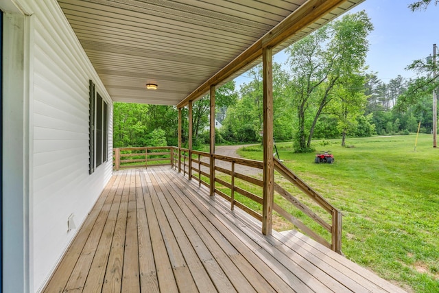 612 Airline Rd, Amherst, ME 04605 - wooden porch featuring a yard and view of scattered trees