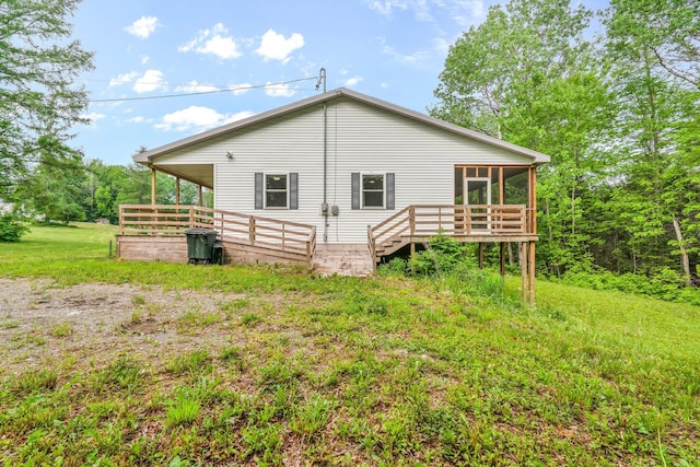 612 Airline Rd, Amherst, ME 04605 - rear view of house with a wooden deck and a sunroom