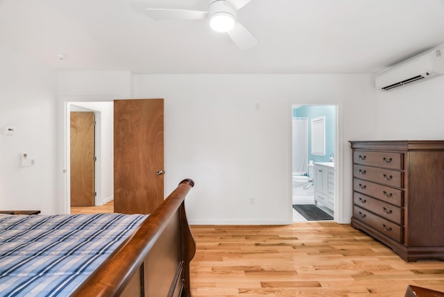 612 Airline Rd, Amherst, ME 04605 - bedroom with a wall unit AC, light wood-style flooring, connected bathroom, and ceiling fan