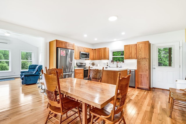 612 Airline Rd, Amherst, ME 04605 - dining room with light wood-type flooring, a wall mounted AC, recessed lighting, and a baseboard heating unit