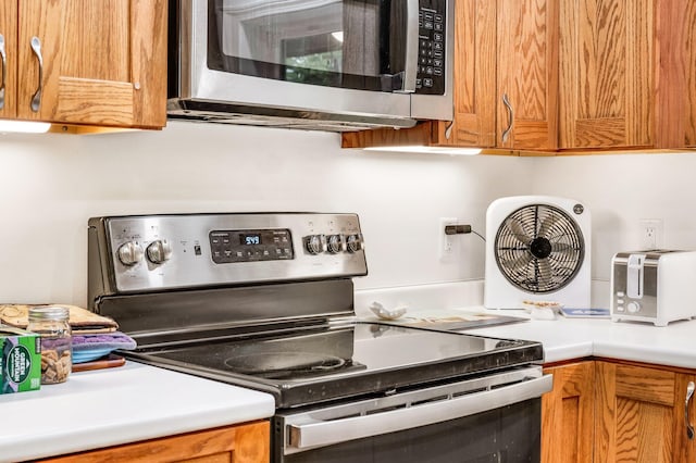 612 Airline Rd, Amherst, ME 04605 - kitchen with stainless steel appliances, light countertops, and brown cabinets