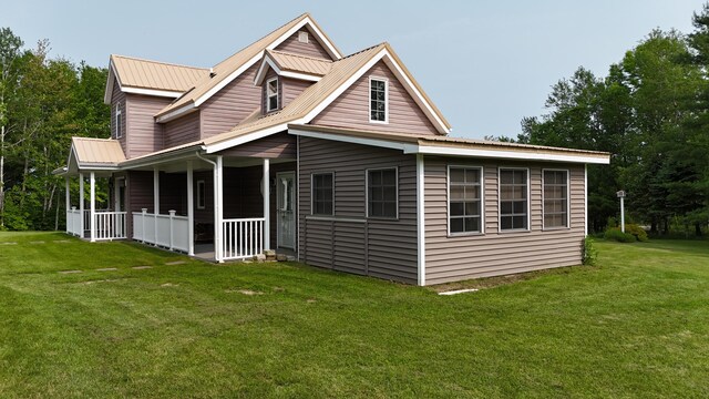 55 Pember Rd, Levant, ME 04456 - view of front of property with a front lawn, metal roof, and covered porch