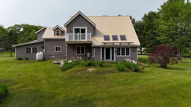 55 Pember Rd, Levant, ME 04456 - rear view of house featuring a lawn, metal roof, a standing seam roof, and a balcony