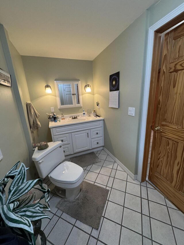 55 Pember Rd, Levant, ME 04456 - bathroom with toilet, vanity, tile patterned flooring, and baseboards