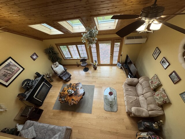 55 Pember Rd, Levant, ME 04456 - living room with a skylight, a wall mounted air conditioner, wood finished floors, a ceiling fan, and wood ceiling