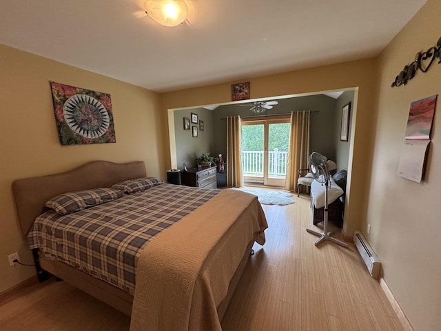 55 Pember Rd, Levant, ME 04456 - bedroom featuring baseboard heating, wood finished floors, baseboards, and access to outside