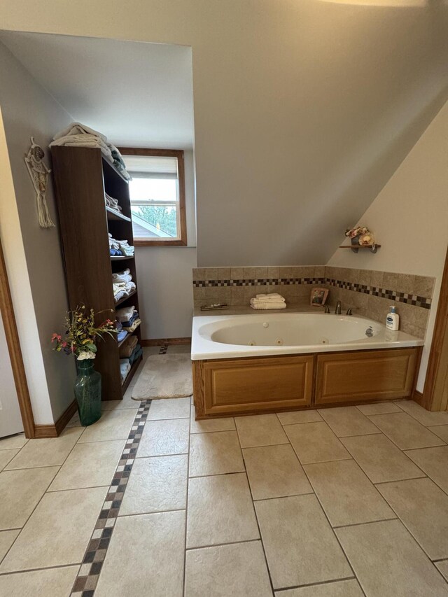 55 Pember Rd, Levant, ME 04456 - bathroom featuring a whirlpool tub, tile patterned flooring, baseboards, and vaulted ceiling