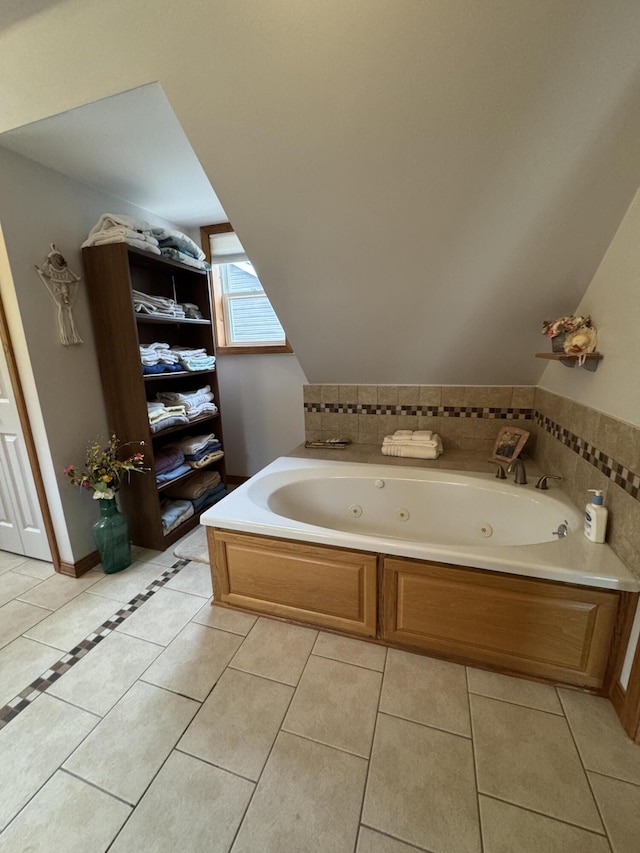 55 Pember Rd, Levant, ME 04456 - bathroom with tile patterned flooring, a tub with jets, and vaulted ceiling