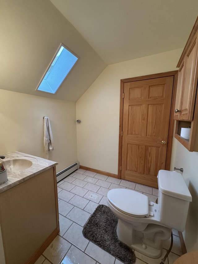 55 Pember Rd, Levant, ME 04456 - bathroom featuring a baseboard heating unit, lofted ceiling, a skylight, toilet, and vanity