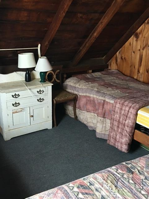 233 Webhannet Dr, Wells, ME 04090 - carpeted bedroom with wooden walls and wood ceiling