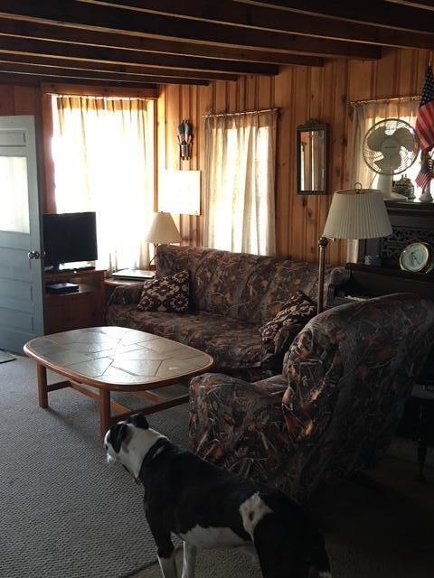 233 Webhannet Dr, Wells, ME 04090 - carpeted living area with wooden walls