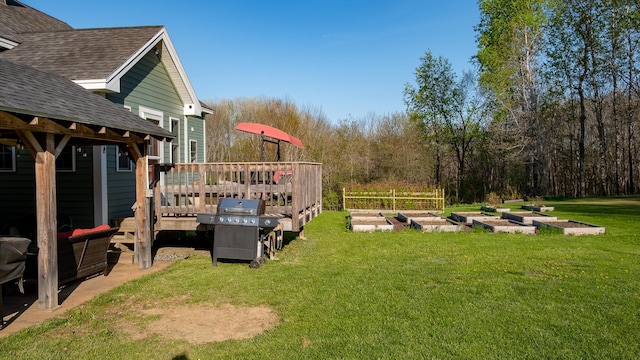 815 Grant Rd, Corinth, ME 04427 - view of grassy yard with a vegetable garden and a deck