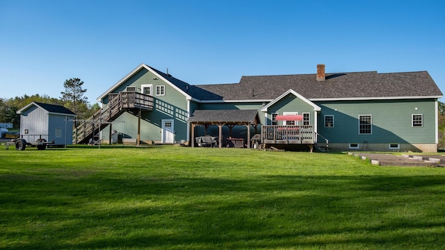 815 Grant Rd, Corinth, ME 04427 - rear view of property featuring stairs, a deck, a yard, a chimney, and a shingled roof