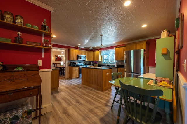 815 Grant Rd, Corinth, ME 04427 - kitchen featuring stainless steel appliances, crown molding, an ornate ceiling, wainscoting, and brown cabinets