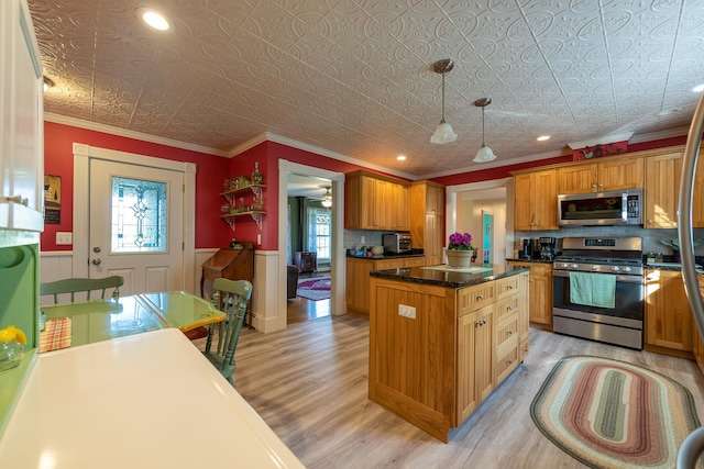 815 Grant Rd, Corinth, ME 04427 - kitchen featuring stainless steel appliances, light wood-style flooring, an ornate ceiling, a kitchen island, and wainscoting