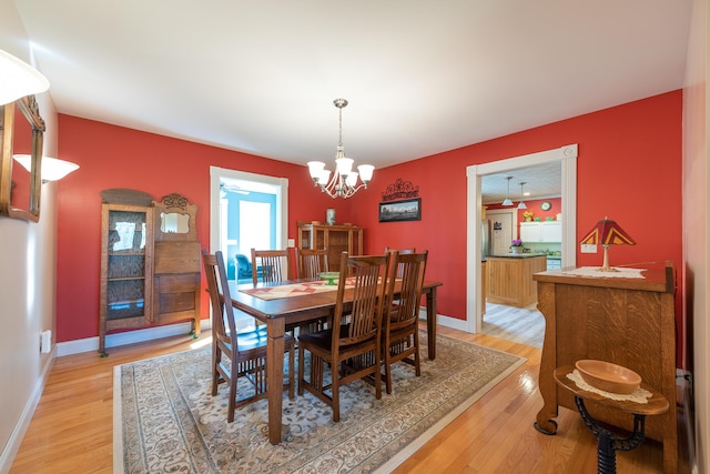 815 Grant Rd, Corinth, ME 04427 - dining room with a chandelier and light wood-style floors