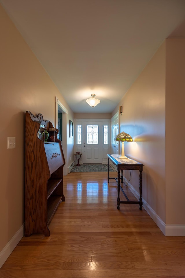 815 Grant Rd, Corinth, ME 04427 - foyer featuring light wood-style flooring and a baseboard heating unit