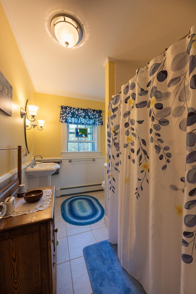 815 Grant Rd, Corinth, ME 04427 - bathroom featuring a baseboard heating unit, ornamental molding, wainscoting, tile patterned floors, and vanity