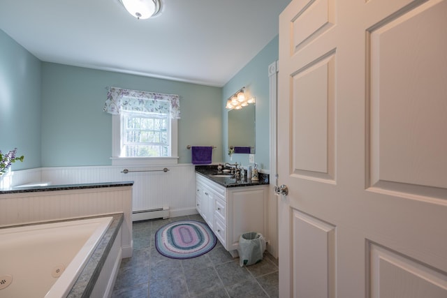815 Grant Rd, Corinth, ME 04427 - full bathroom featuring a baseboard radiator, vanity, a tub with jets, tile patterned flooring, and wainscoting