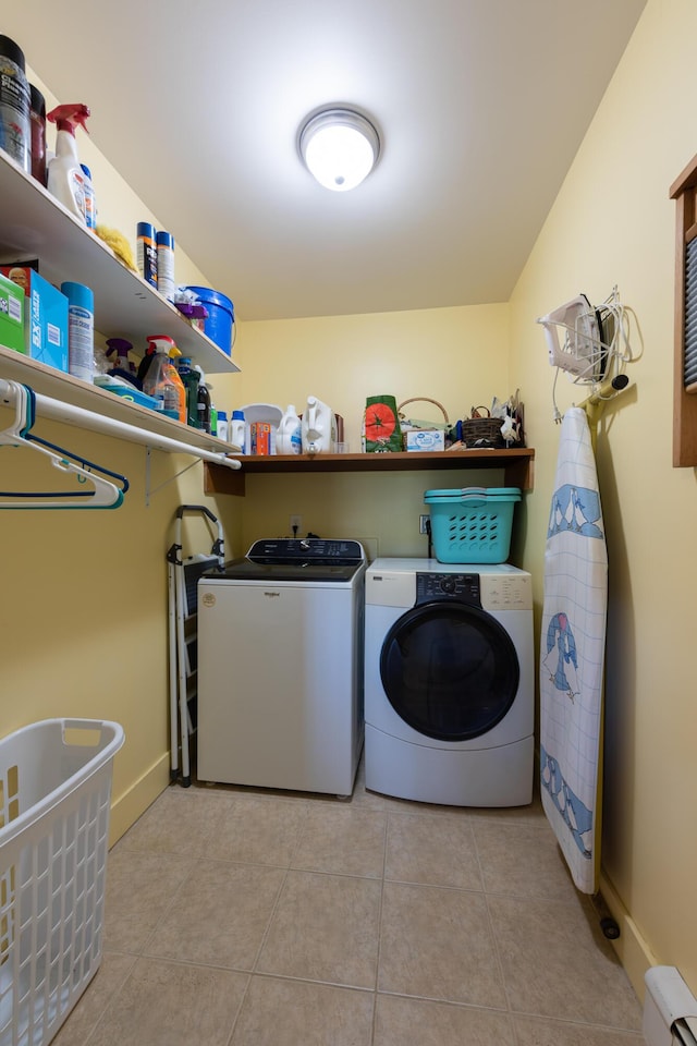 815 Grant Rd, Corinth, ME 04427 - laundry room featuring washing machine and clothes dryer, baseboard heating, and light tile patterned flooring