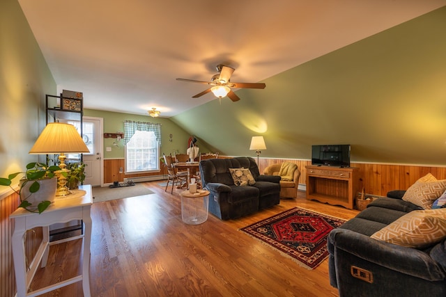 815 Grant Rd, Corinth, ME 04427 - living area featuring a ceiling fan, a wainscoted wall, wood finished floors, vaulted ceiling, and wooden walls