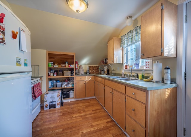 815 Grant Rd, Corinth, ME 04427 - kitchen featuring freestanding refrigerator, light countertops, light wood-style floors, and vaulted ceiling