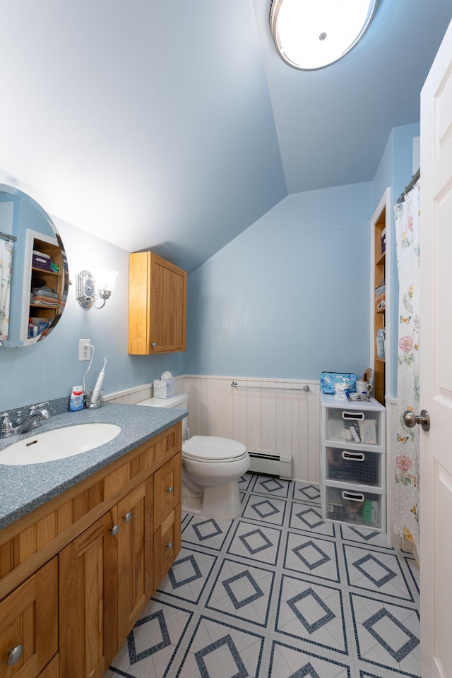 815 Grant Rd, Corinth, ME 04427 - full bath with lofted ceiling, a baseboard radiator, a wainscoted wall, and vanity