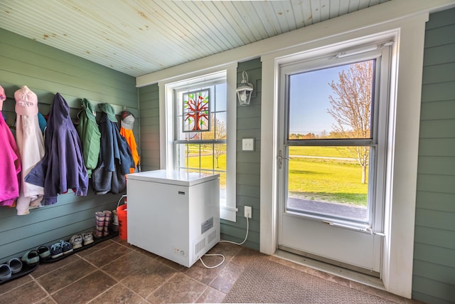 815 Grant Rd, Corinth, ME 04427 - doorway featuring wood walls and wooden ceiling