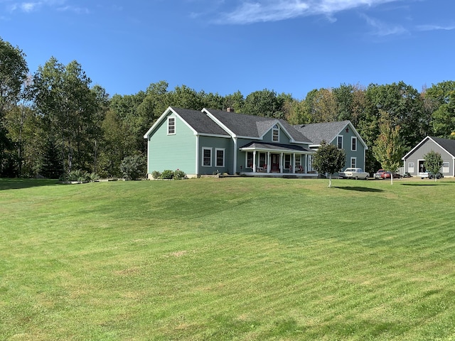 815 Grant Rd, Corinth, ME 04427 - view of front of home with a porch, a front yard, and a chimney