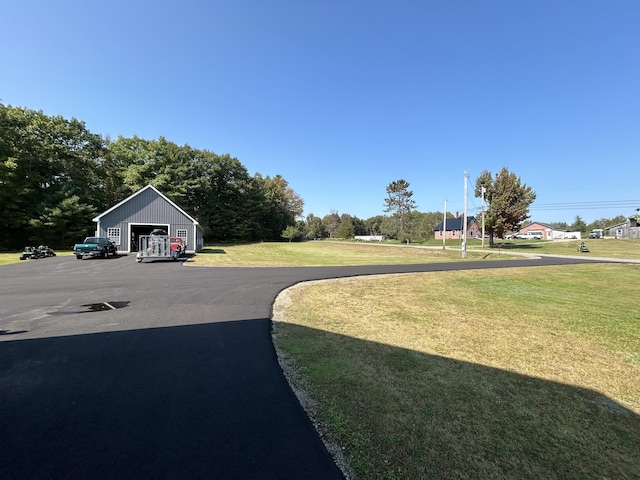815 Grant Rd, Corinth, ME 04427 - view of grassy yard with a garage and an outbuilding